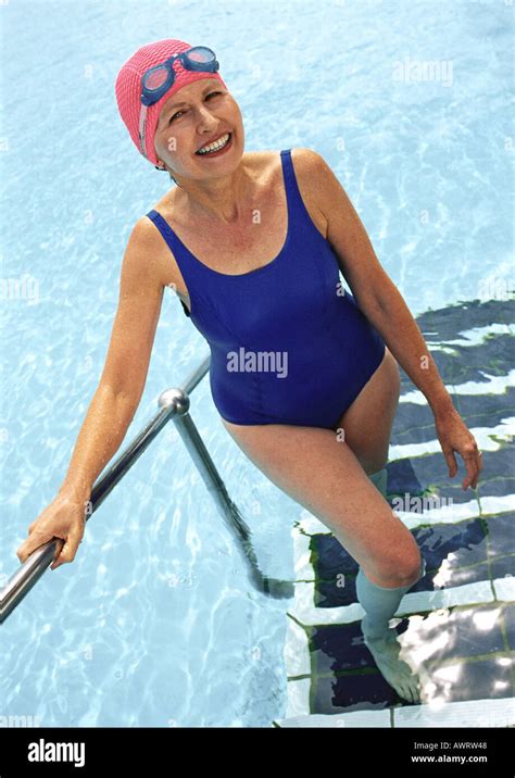 Mature Woman Coming Out Of Swimming Pool Smiling Stock Photo Alamy