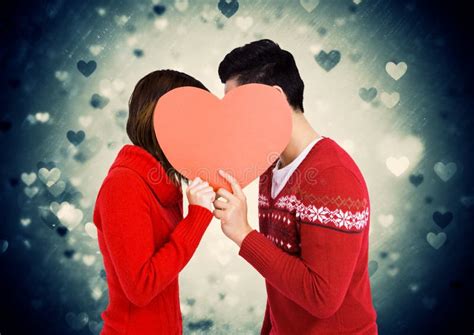 Romantic Couple Holding Heart Shape And Kissing Each Other Stock Photo