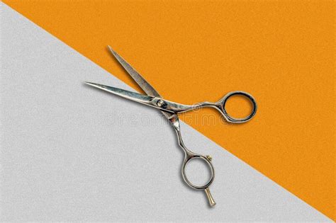 Hairdressing Scissors On A Gray Orange Geometric Background Beauty And