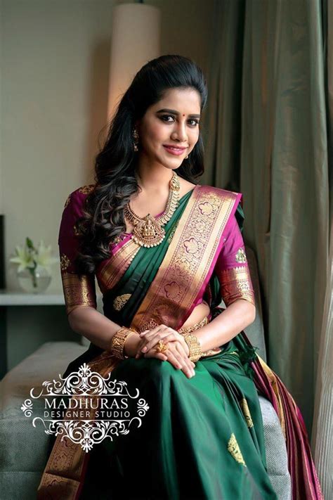Stunning Nabha Natesh In Bottle Green Color Saree And Purple Color Blouse Blouse With Han