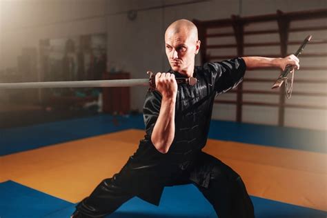 Premium Photo Wushu Master Training With Sword Martial Arts