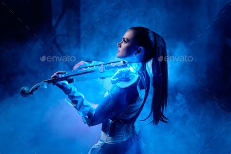 Beautiful Violinist Girl Playing Violin On Stage With Neon Light And