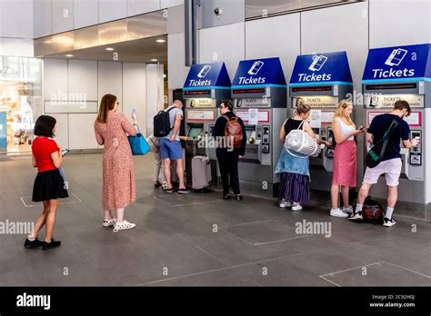 People Using The Ticket Machines At London Bridge Station London