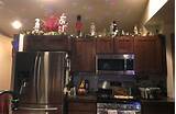 Wonderful job on decorating above your kitchen cabinets. Christmas decorations above the kitchen cabinets. Lights, garland and nutcrackers set on a timer ...