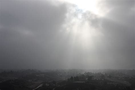 Free Stock Photo Of Sunlight Shining Through Thick Clouds Over Hazy Town