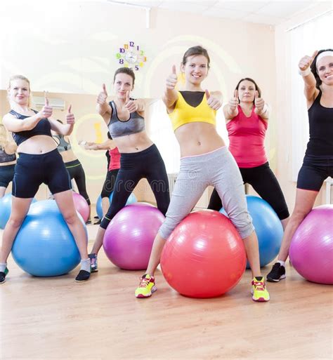 Group Of Five Caucasian Female Athletes Having Exercises With Fitballs