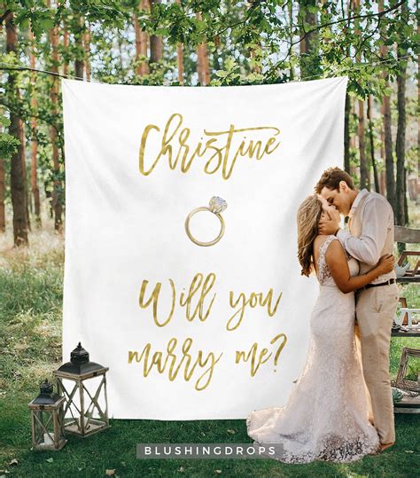 A Bride And Groom Kissing In Front Of A Wedding Banner With The Words