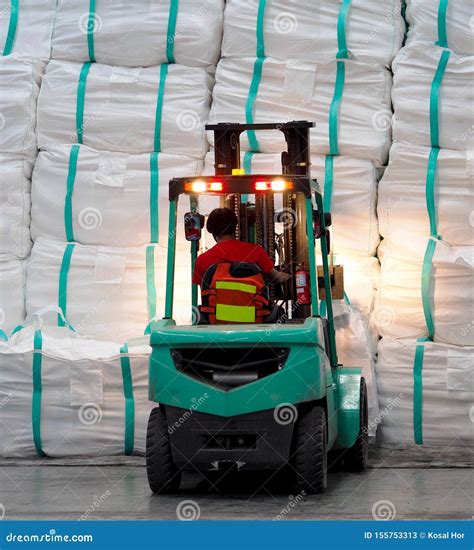Forklift Operation in Warehouse, Lifting Cargo in Jumbo Bag into Stack