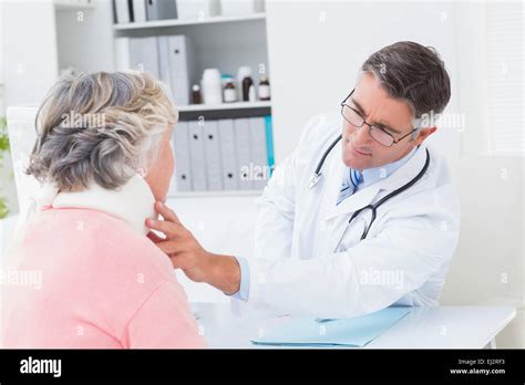 Doctor Examining Female Patient Wearing Neck Brace Stock Photo Alamy