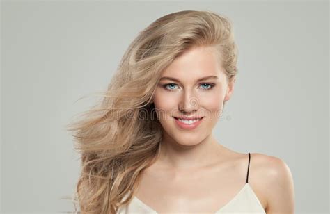 Beautiful Woman With Perfect Blonde Hairstyle And Clear Skin Smiling On