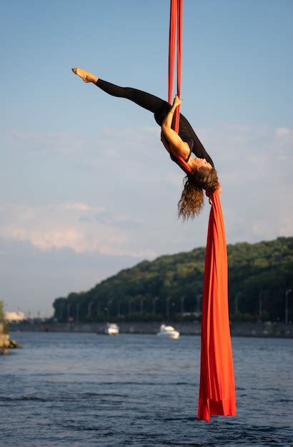 premium photo beautiful and flexible female circus artist dancing with aerial silk