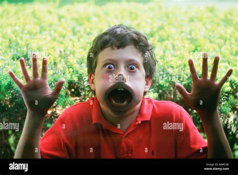 Young Boy Pressing His Face Against Glass Window Stock Photo Alamy