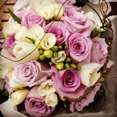 Freesias don't just look fabulous, they smell fabulous too. Mauve and white wedding bouquet made with freesias, tulips ...