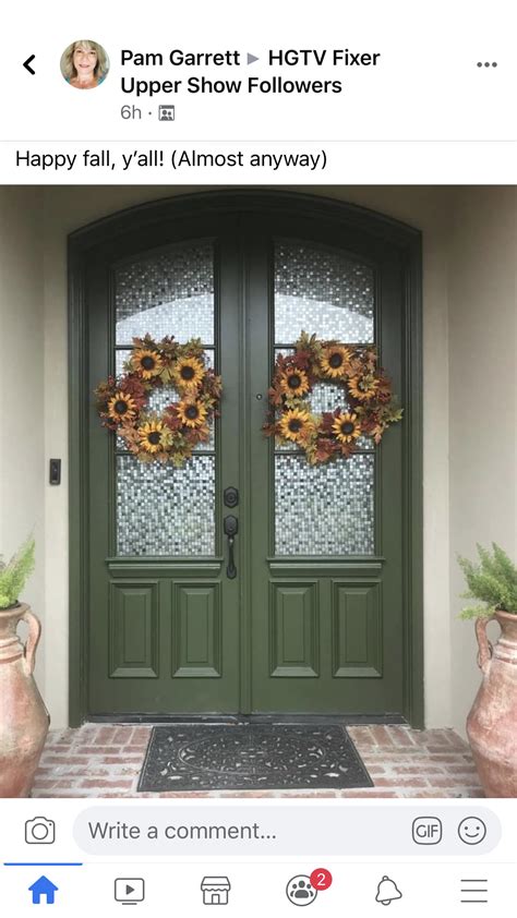 A Green Door With Sunflower Wreaths On It