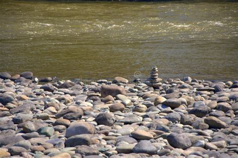 The Swift Mountain River Carries Its Waters In The Rocky Shores Through