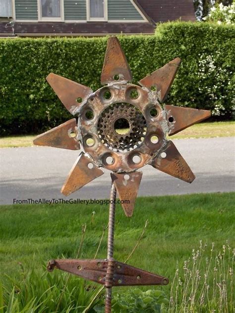 A Metal Star With Holes In The Middle Of It Sitting On Top Of Some Grass