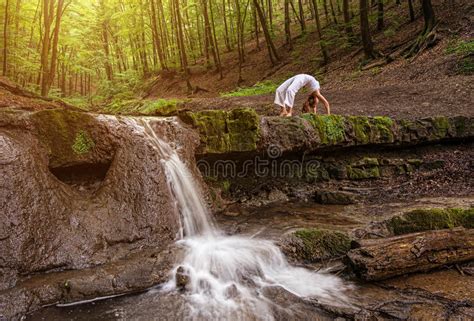 Relaxation In Forest At The Waterfall Ardha Padmasana Pose Stock Photo