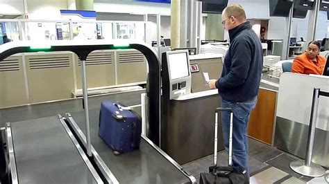 Passengers Using Self Service Bag Drop At Brisbane Domestic Airport
