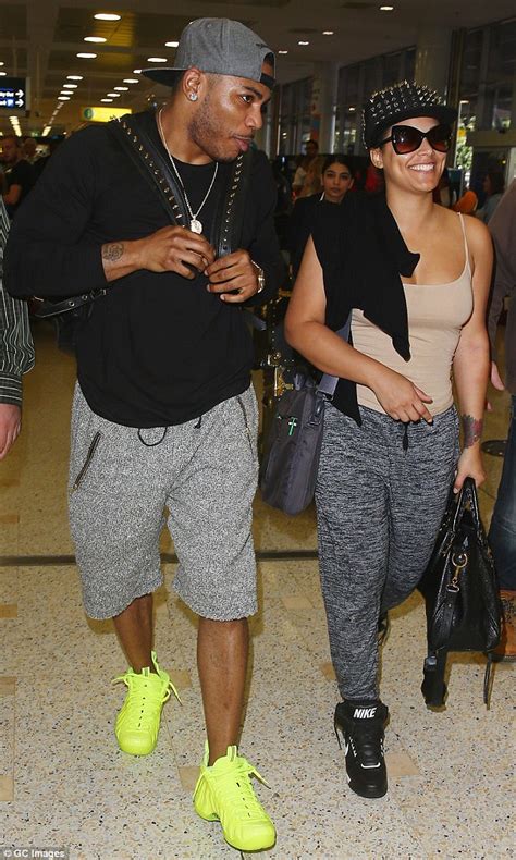 Nelly Keeps His Muscular Arm Around Girlfriend Shantel Jackson As He Jets Into Sydney Daily
