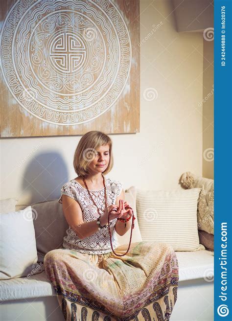 The Concept Of Zen Peace Balance A Woman Sits On A Sofa And Meditates Using Mudra Keeping