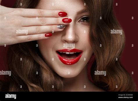Beautiful Girl With A Classic Make Up Curls Hair And Red Nails Manicure Design Beauty Face