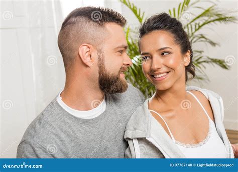 Portrait Of Young Smiling Sweethearts Sitting Together Stock Photo