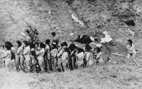 Naked Jewish Women Some Of Whom Are Holding Infants Wait In A Line Before Their Execution By