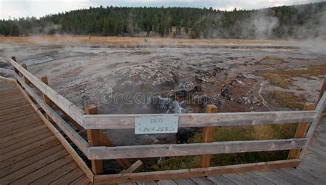 boardwalk curving around hot cascades hot spring in the lower geyser basin in yellowstone