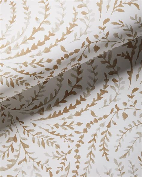 A White And Gold Wallpaper With Leaves On It