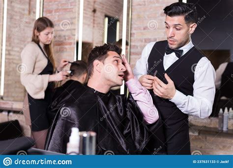 Unpleasantly Surprised Man And Hairdresser Regretting In Salon Stock