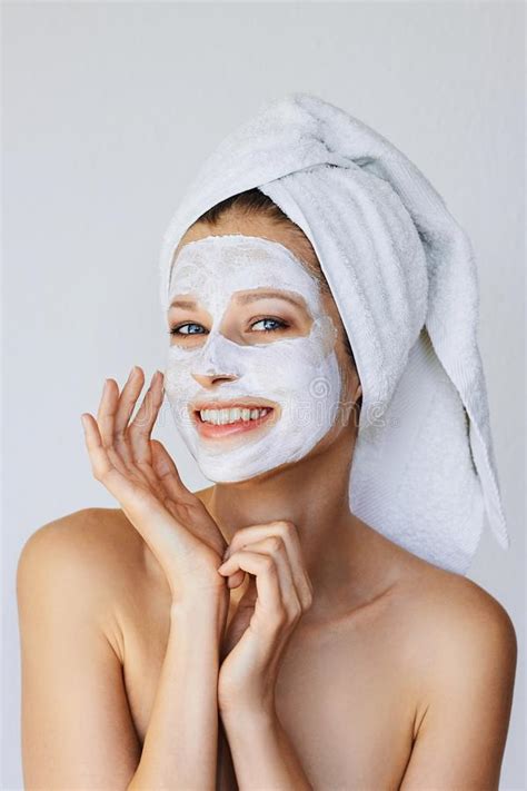 Beautiful Young Woman Applying Facial Mask On Her Face Skin Care And