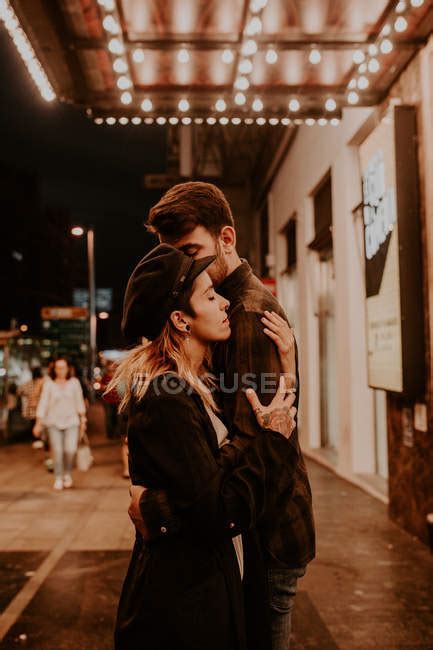 Side View Of Couple Sensually Embracing On Evening Street — Young