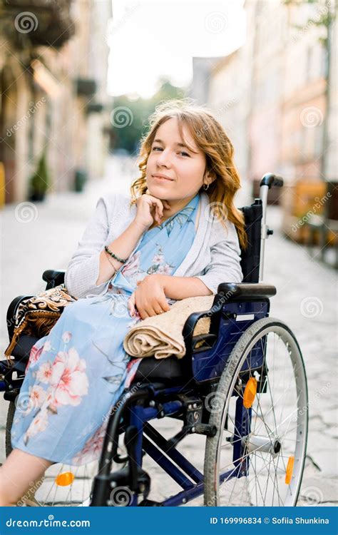 Closeup Portrait Of Pretty Young Smiling Disabled Woman In Blue Dress