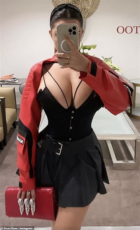 Demi Rose Puts On A VERY Busty Display And Shows Off Her Tiny Waist In A Black Corset Mini Dress