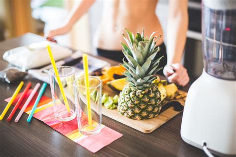 Fit Woman Preparing Smoothie In The Kitchen