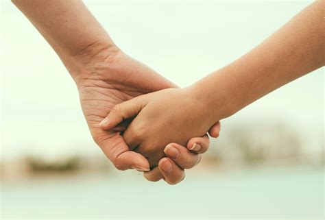 Mother Holding Hand Of Her Daughter Stock Photo Download Image Now