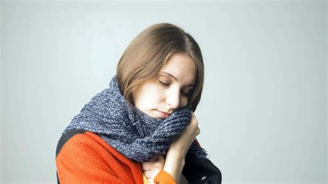 Download Shivering Woman Holding Scarf Wallpaper Wallpaper