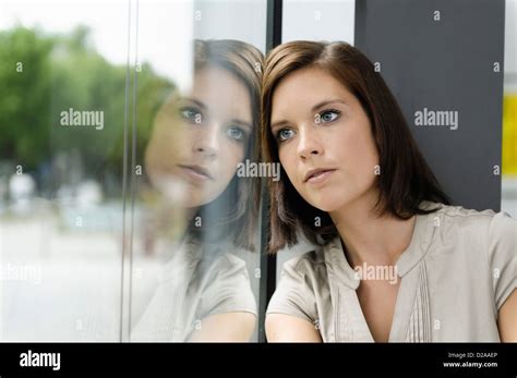 Businesswoman Leaning Against Window Stock Photo Alamy