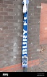 Football fan solidarity is shown by a Bury FC scarf placed outside the ...