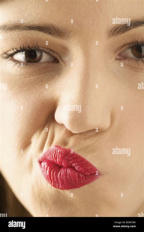 A Woman Puckering Her Lips To The Side Stock Photo Alamy