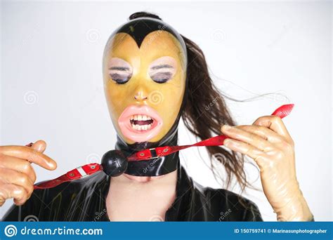 Hot Curvy Crossdresser Wearing Latex Rubber Mask And Black Fetish Costume Kinky Person With