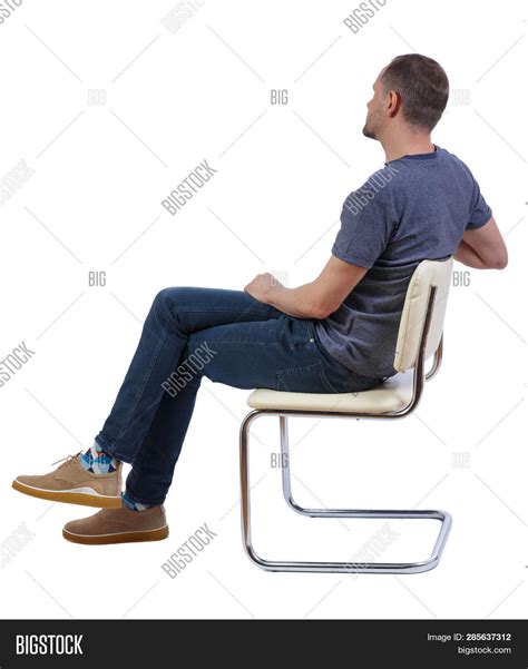 Man Sitting Cross Legged In Chair