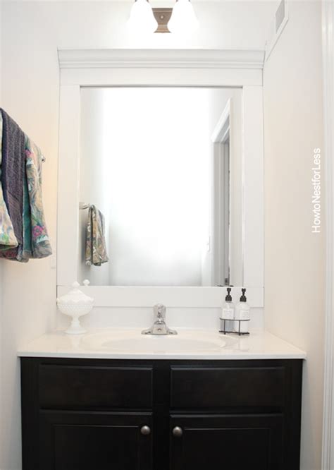 Are you wanting learn how to frame a bathroom mirror but can't figure out how to get around those pesky mirror clips? How to Frame a Bathroom Mirror - How to Nest for Less™