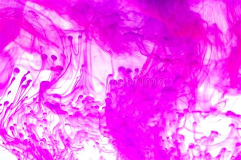 Pink Paint Dissolving In Water With White Background Stock Photo