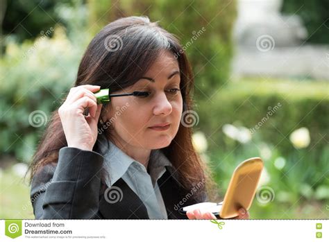 woman puts make up stock image image of holding makeup 79347937