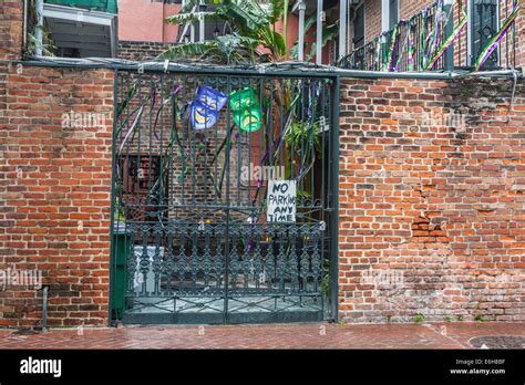 Mardi Gras Masks And A No Parking Sign On A Wrought Iron Fence At
