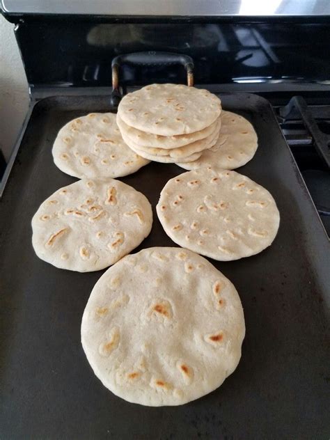 Four Tortillas Sitting On Top Of A Black Pan