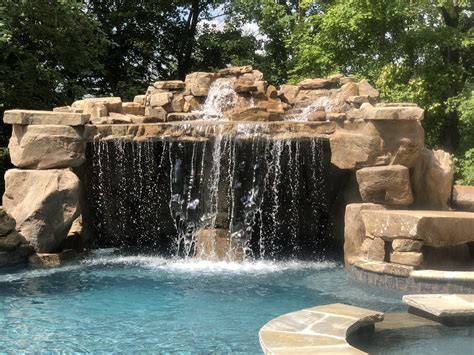 A Stunning Cave Water Feature With A Waterfall In A Concrete Pool Custom Swimming Pool Pool