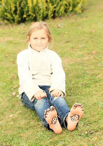 Girl With Smileys On Toes And Soles Stock Photo Image Of Lying