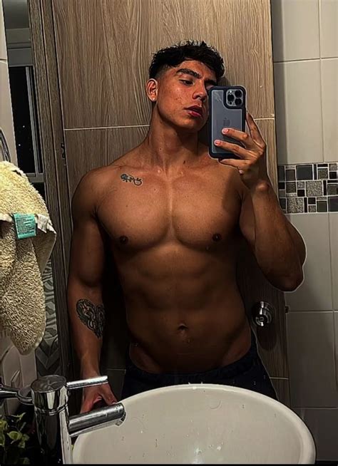 A Shirtless Man Taking A Selfie In Front Of A Bathroom Mirror With His